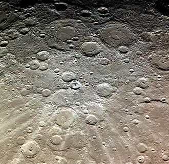 Exaggerated color image by MESSENGER with Dickens right of center