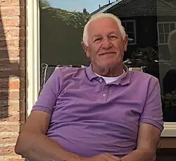Hans Hoogveld sitting in a purple shirt