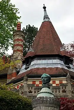 Close-up architectural detail showing ornate Gothic stonework on a building roof