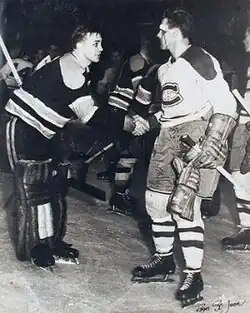Richard, with blood on his face, shakes hands with goaltender Jim Henry, who is hunched forward in a slight bow
