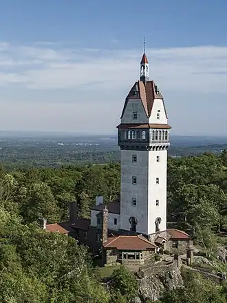 A tower on a forested hill