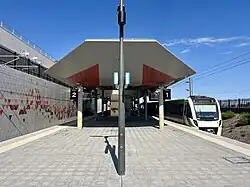 Tiled island platform with train on the right