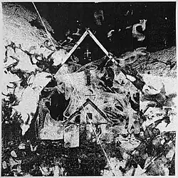 An abstract black and white album cover with a small house and flames overlayed