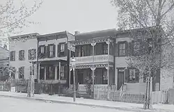 A photograph of four rowhouses