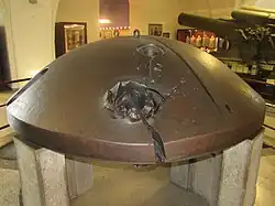 A turret cupola from one of Antwerp's fortresses hit and split by a 30.5&nbsp;cm shell during the Siege of Antwerp in 1914.