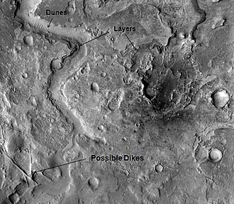 Straight ridges may be dikes in which liquid rock once flowed. The image is of Huo Hsing Vallis in Syrtis Major, as seen by THEMIS.