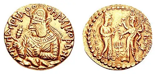Coinage of Kushan ruler Huvishka with, on the reverse, the divine couple Ommo ("ΟΜΜΟ", Umā) holding lotus flower, and Oesho ("ΟΗϷΟ", Shiva) with four arms holding attributes. Circa 150-180 CE.