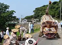Large papier-mache tiger on a road.