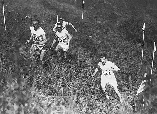 Image 24Edvin Wide, Ville Ritola, and Paavo Nurmi (on left) competing in the individual cross country race at the 1924 Summer Olympics in Paris; due to the hot weather, which exceeded 40 °C (104 °F), only 15 out of 38 competitors finished the race. (from Cross country running)