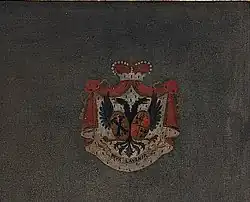 Red, white and blue coat of arms against a dark flat background