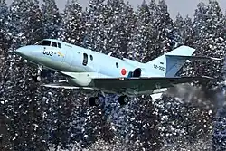 An U-125A aircraft taking off in the winter.