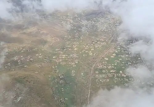 Aerial view of the ruined city, showing destroyed houses