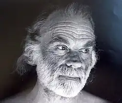 Black-and-white photo of a bearded James Broughton looking off-camera