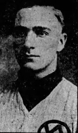 Black and white photo of a young adult man in a baseball uniform