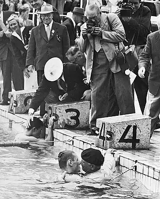 After Jean Boiteux won the 400 m freestyle race his father jumped into the pool to congratulate him