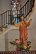 Statue of Jesus and the stairs that lead up to the balcony inside the Church