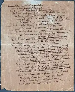 A white sheet of paper that is completely filled with a poem in cursive hand writing. Many of the lines mid-way down the page are crossed out.