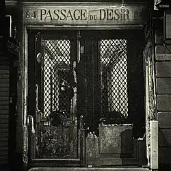 A graphic of a door with the title of the album above it