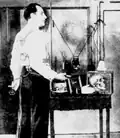 Dunninger with equipment used to duplicate the tricks of spiritualist mediums. A portable wireless set is strapped to his back