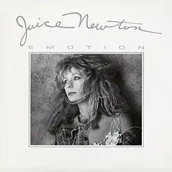 Sepia-toned head shot of an attractive woman with tousled brown hair