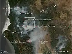 The satellite image shows various plumes of smoke coming from Northern California. The location of various fires is labelled. The Pacific Ocean is visible to the left of the image.