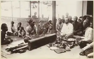 Wayang beber performance of the desa Gelaran at the home of Dr. Wahidin Soedirohoesodo at Yogyakarta; in the middle Dr. GAJ Hazeu, Dutch East Indies, in 1902