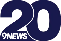 A navy blue thick numeral 20 with the top of the 2 delineated from the otherwise overlapping 0. In the base of the 2 is the 9News logo, a stylized 9 next to the italicized word NEWS.