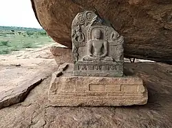 Rock Cut Bas Relief And Beds And A Mutilated Jain Stone Image