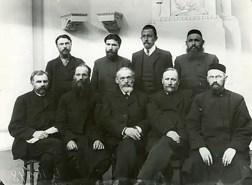 Formal photo of nine men