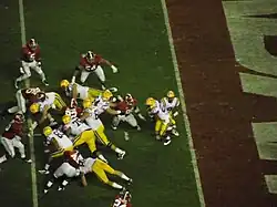 American football players running a running play.