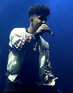 Kyle performing with a microphone in his hand