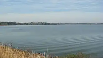 A view of the calm Lake Tobesofkee in the wintertime. Taken facing Northwest from beside the Lower Thomaston Road Bridge.
