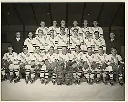 Black and white photo of hockey team, two rows standing behind one row seated