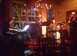 Richard Terrill (center) playing saxophone with the Larry McDonough Quartet in 2018