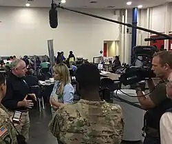 Laura Sullivan interviewing a FEMA manager after Hurricane Harvey in 2017 at the Houston Convention Center