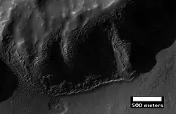 Layers in mantle deposit, as seen by HiRISE, under the HiWish program. Mantle was probably formed from snow and dust falling during a different climate.