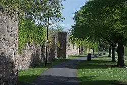 The remains of the abbey's stone precinct walls date from the 13th century
