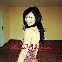 A single cover with a dark-haired woman (Philipsson), wearing a red dress in a room with yellow walls, while looking over her shoulder into the camera.