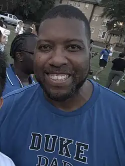 Headshot of Williams in a blue shirt, outdoors
