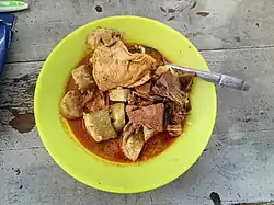 Lontong gulai ayam, an Indonesian dish featuring lontong (compressed rice cakes) served with chicken gulai