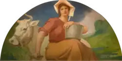 Woman dressed as dairy maid, with pale on her lap while her other arm is resting on a milk churn. Behind her is a white cow.