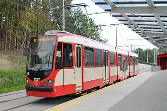 Three-section tram, the door in the centre section is lower than those in the end sections.
