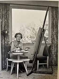 Madame Elizabeth Shoumatoff with paintbrush in hand at her Long Island Studio