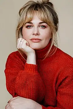 Headshot of Maddy Foley wearing a red sweater