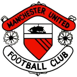 A football crest. In the centre is a shield with a ship in full sail above a red field with three diagonal black lines. On either side of the shield are two stylised roses, separating two scrolls. The upper scroll is red and reads "Manchester United" in black type, while the lower scroll is white with "Football Club" also written in black