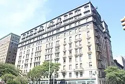 The Broadway facade as seen from 109th Street. The facade is divided vertically into 11 bays, each with a varying number of windows. The base is clad with limestone, while the third through ninth stories are clad with salmon-colored bricks. There is a black metal mansard roof on the tenth and eleventh stories.