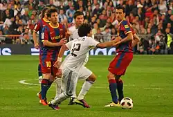 Real Madrid's Marcelo and Xabi Alonso taking on Barcelona's Lionel Messi and Sergio Busquets during a 2011 Clásico.
