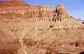 Marsh Butte (end of ridge) formed in Redwall Limestone. Tapeats Sandstone (brown cliff at bottom of photograph), Manakacha Formation (red cliff at top of photograph).