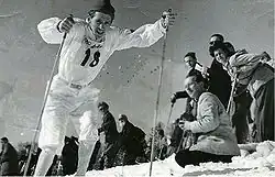 Martin Lundström skiing with an audience at the right side.