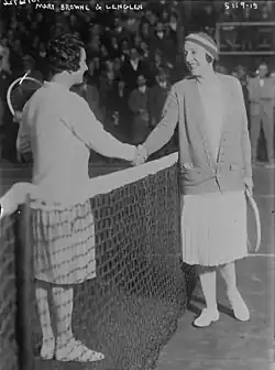 Lenglen and Browne smiling and shaking hands at the net